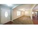 Open-concept living room with plush carpeting, lots of natural light, and a smooth transition to other rooms at 292 S Prospect Ave, Waco, GA 30182