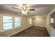 Sun-filled living room with ceiling fan and neutral walls offering a serene and inviting space at 292 S Prospect Ave, Waco, GA 30182