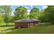 Brick ranch home with well-maintained lawn and mature trees at 292 S Prospect Ave, Waco, GA 30182