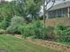 Backyard of home with lush landscaping, rock wall and iron fencing at 834 Chalet Hills, Mcdonough, GA 30253