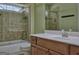 Bathroom with shower, tile surround, wooden cabinets and a large mirror at 834 Chalet Hills, Mcdonough, GA 30253