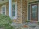 Inviting front porch featuring stone accents, a stately column, and a decorative glass front door at 834 Chalet Hills, Mcdonough, GA 30253
