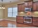 Well-equipped kitchen with stainless steel appliances, granite countertops, and rich wood cabinetry at 834 Chalet Hills, Mcdonough, GA 30253