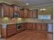 Well-equipped kitchen with stainless steel appliances, granite countertops, and rich wood cabinetry at 834 Chalet Hills, Mcdonough, GA 30253