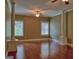 Bright and airy living room features hardwood floors, large columns, and natural light from multiple windows at 834 Chalet Hills, Mcdonough, GA 30253