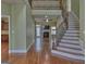 Open-concept living area with a cozy fireplace, hardwood floors, and a staircase to the second level at 834 Chalet Hills, Mcdonough, GA 30253
