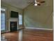 Bright living room featuring hardwood floors, a classic fireplace, and views to the outdoors at 834 Chalet Hills, Mcdonough, GA 30253