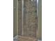 Bathroom showcasing a tiled shower with glass door and built-in shelves for convenience at 834 Chalet Hills, Mcdonough, GA 30253