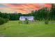 Wide aerial view of a sprawling property with a well-manicured lawn, mature trees, and a grand residence at 368 Ginger Cake Rd, Fayetteville, GA 30214
