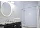 Clean bathroom featuring a granite-topped vanity, round mirror, and a shower-tub combination with white subway tile at 368 Ginger Cake Rd, Fayetteville, GA 30214