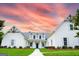 Stunning exterior showcasing a manicured lawn, charming shutters, and inviting entrance under a beautiful sunset at 368 Ginger Cake Rd, Fayetteville, GA 30214