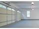 Spacious garage with a multi-panel garage door, ample lighting, and smooth concrete flooring at 368 Ginger Cake Rd, Fayetteville, GA 30214