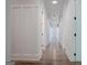 Hallway featuring beautiful hardwood floors, white board and batten wainscotting and recessed lighting at 368 Ginger Cake Rd, Fayetteville, GA 30214