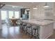 Beautiful open concept kitchen with a large island and bar stools, connecting to the dining area at 368 Ginger Cake Rd, Fayetteville, GA 30214