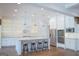 Well-lit kitchen with a large island with barstool seating, stainless steel appliances, and plenty of cabinet space at 368 Ginger Cake Rd, Fayetteville, GA 30214