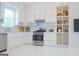 Bright, white kitchen featuring stainless steel appliances, subway tile backsplash, and stylish open shelving at 368 Ginger Cake Rd, Fayetteville, GA 30214