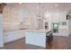 A modern kitchen with white cabinetry, granite countertops, stainless steel appliances, and a spacious island at 368 Ginger Cake Rd, Fayetteville, GA 30214