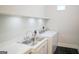 Functional laundry room with stainless steel sink, modern washer, and ample counter space for folding at 368 Ginger Cake Rd, Fayetteville, GA 30214