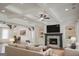 An elegant living room featuring a stone fireplace, coffered ceiling, and lots of natural light at 368 Ginger Cake Rd, Fayetteville, GA 30214