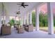 Inviting outdoor porch with comfortable seating, ceiling fans, and serene views of the surrounding landscape at 368 Ginger Cake Rd, Fayetteville, GA 30214
