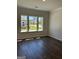 Bedroom with hardwood floors and three windows offering a scenic outside view at 3706 Cheswoilde Ave # 96, Powder Springs, GA 30127