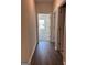 Hallway with wood flooring leading to bedroom with natural light at 3706 Cheswoilde Ave # 96, Powder Springs, GA 30127