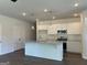 Open kitchen with stainless steel appliances, granite counters, white cabinets, island, and pendant lighting at 3706 Cheswoilde Ave # 96, Powder Springs, GA 30127