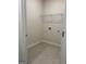 Bright laundry room features tile flooring and wire shelving for storage at 3706 Cheswoilde Ave # 96, Powder Springs, GA 30127