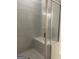 Tiled shower with built-in seat and glass door at 3706 Cheswoilde Ave # 96, Powder Springs, GA 30127