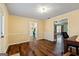 Spacious hallway with hardwood floors providing access to the kitchen and other rooms at 105 Meadow Spring'S Ct, Locust Grove, GA 30248