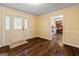 Hallway with hardwood floors, leading to a kitchen and a front door with side windows at 105 Meadow Spring'S Ct, Locust Grove, GA 30248