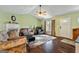Inviting living room featuring a fireplace, ceiling fan, and hardwood floors at 105 Meadow Spring'S Ct, Locust Grove, GA 30248