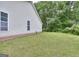 Backyard with a well-maintained lawn and a border of woods at 702 Brambling Way, Stockbridge, GA 30281