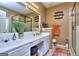 Bright bathroom with double sinks, a large mirror, updated shower, and tiled floors at 702 Brambling Way, Stockbridge, GA 30281