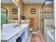Bright bathroom with a modern vanity, large mirror, updated shower, and tiled floors at 702 Brambling Way, Stockbridge, GA 30281