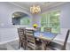 Dining room with a wooden dining table set for six, view of the kitchen through an arched passthrough at 702 Brambling Way, Stockbridge, GA 30281