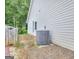 View of the side of the house, with an AC Unit and a fence at 702 Brambling Way, Stockbridge, GA 30281