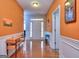 Inviting foyer with warm orange walls, hardwood floors, and white trim, leading to other rooms of the home at 702 Brambling Way, Stockbridge, GA 30281