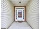 View of the front door with white trim, sidelights, and a brick surround, offering a welcoming entrance to the home at 702 Brambling Way, Stockbridge, GA 30281