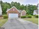 Attractive single-Gathering brick home with lush front yard and attached garage at 702 Brambling Way, Stockbridge, GA 30281