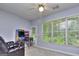 Bright game room features a large window, ceiling fan, arcade game and comfortable recliner at 702 Brambling Way, Stockbridge, GA 30281