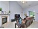 Cozy living room with a fireplace, mantel, and vaulted ceiling, creating a warm and inviting atmosphere at 702 Brambling Way, Stockbridge, GA 30281
