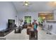 Comfortable living room with vaulted ceilings, neutral carpet, and open access to the kitchen and dining area at 702 Brambling Way, Stockbridge, GA 30281