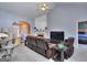 Open-concept living room featuring a fireplace, vaulted ceilings, and a view into the foyer and dining area at 702 Brambling Way, Stockbridge, GA 30281