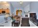 Spacious living room with vaulted ceilings, a fireplace, and seamless access to the kitchen and front entrance at 702 Brambling Way, Stockbridge, GA 30281