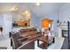 Bright living room with fireplace, vaulted ceiling, and views into the kitchen, dining area, and front foyer at 702 Brambling Way, Stockbridge, GA 30281