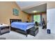 A carpeted main bedroom features a queen size bed, walk-in closet, and vaulted ceiling at 702 Brambling Way, Stockbridge, GA 30281
