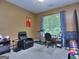 Bright office space with a window, desk, chair, treadmill, and black leather lounge chair at 702 Brambling Way, Stockbridge, GA 30281