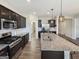 Modern kitchen with stainless appliances, dark cabinets, and granite countertops. Wood floors throughout at 376 Layfield Dr, Jonesboro, GA 30238