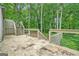 Backyard patio features wood and metal railings and stairs surrounded by trees at 1213 Laurel Cliff Se Dr, Smyrna, GA 30082